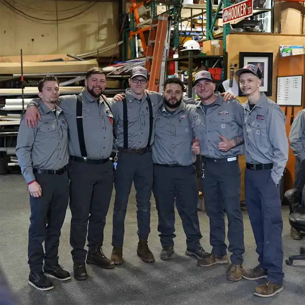 Six Martel service specialists smiling together.
