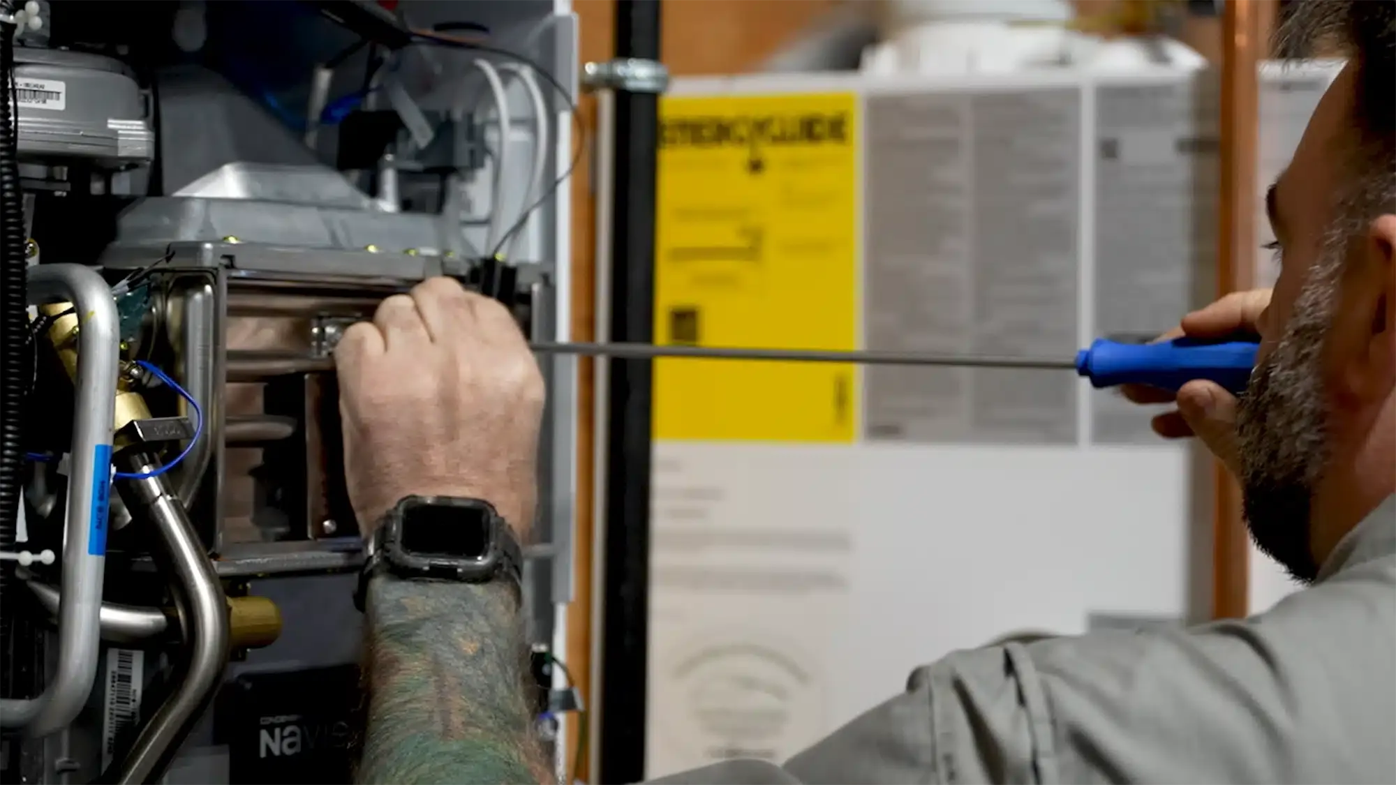 Service tech working on water heater