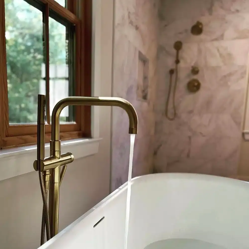 bathtub with gold faucet