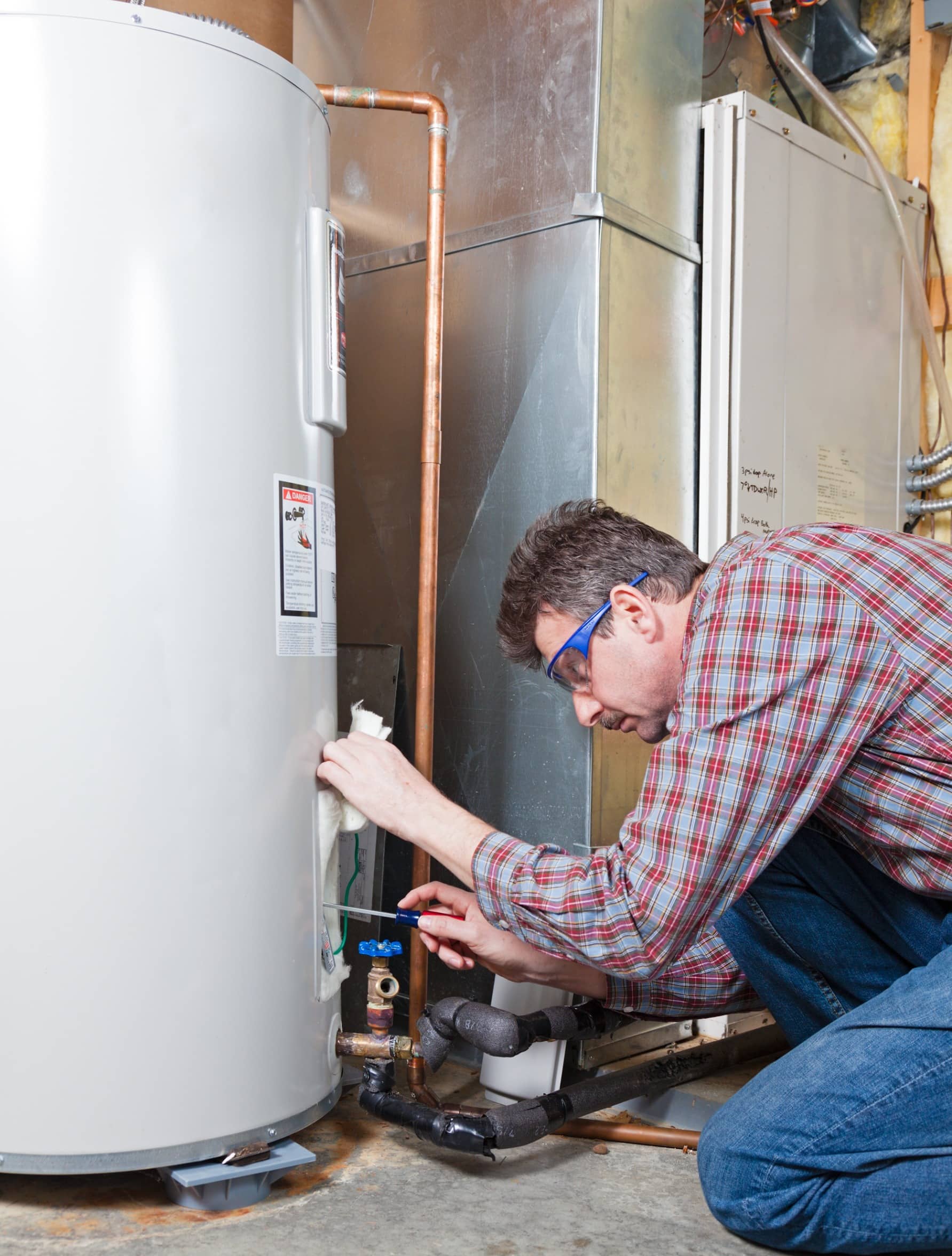 man looking at boiler