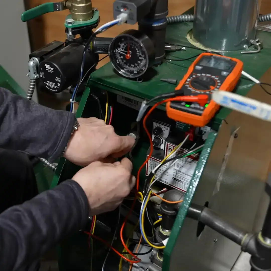 Martel service specialist working with a multimeter.