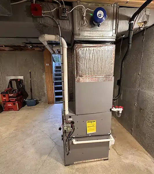 New high-efficiency furnace with air handler coil and whole-home humidifier installed in a Providence area home